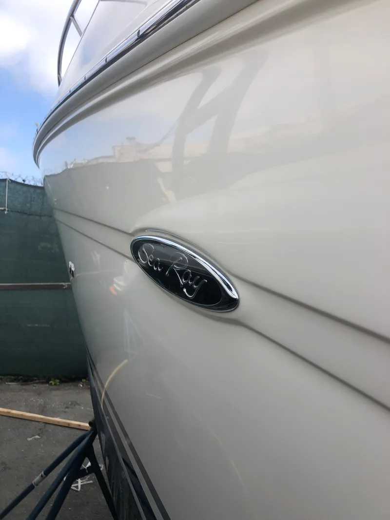 Slide: The Image of 2007 Sea Ray 240 Sundancer boat side view with logo. - 18