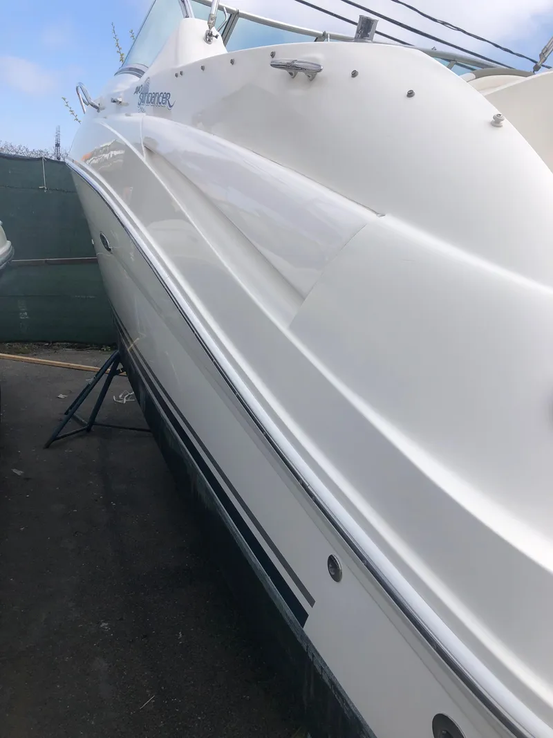 Slide: The Image of 2007 Sea Ray 240 Sundancer boat, white exterior, docked on land. - 20