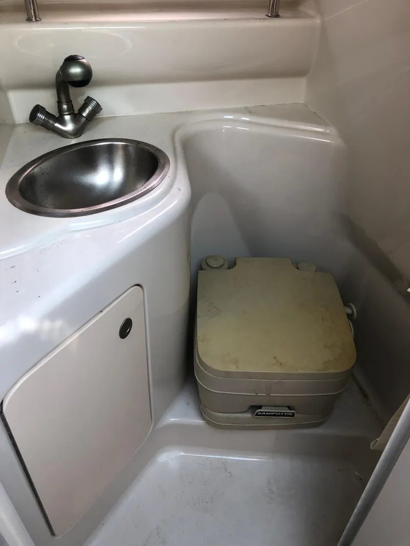 Slide: The Image of 2007 Sea Ray 240 Sundancer bathroom with sink and portable toilet. - 22