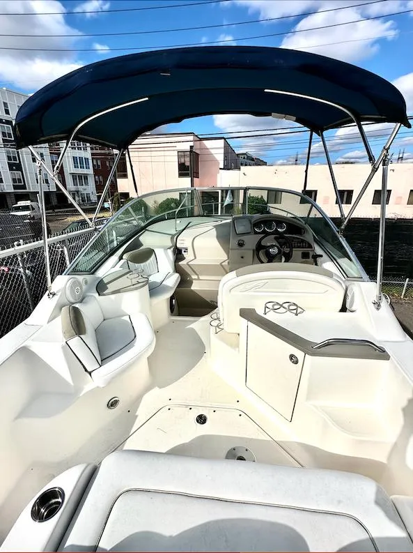 Slide: The Image of 2007 Sea Ray 240 Sundancer boat with canopy, featuring spacious seating and modern dashboard. - 24