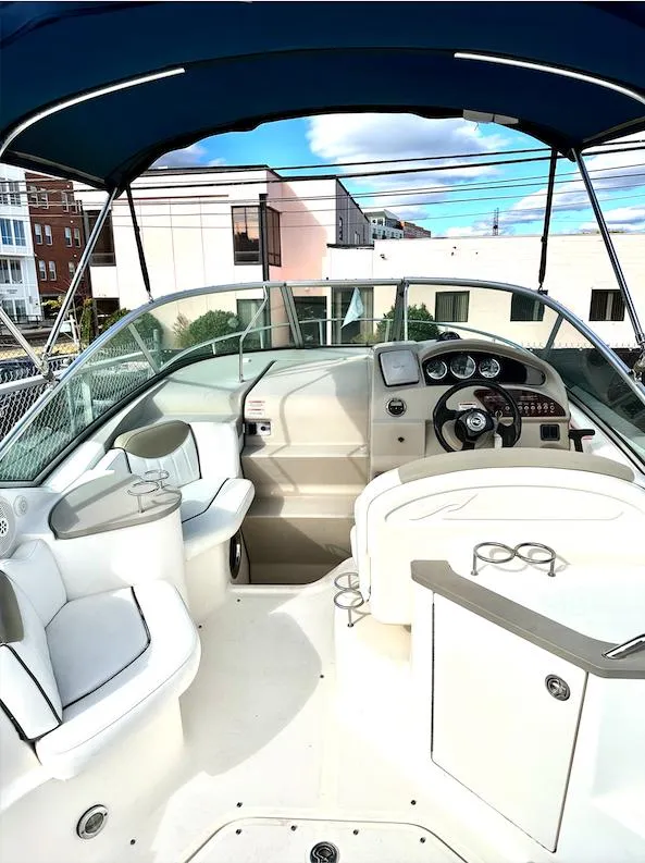 Slide: The Image of 2007 Sea Ray 240 Sundancer boat interior with helm, seating, and canopy. - 25