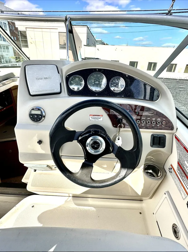 Slide: The Image of 2007 Sea Ray 240 Sundancer helm with steering wheel and instrument panel. - 27