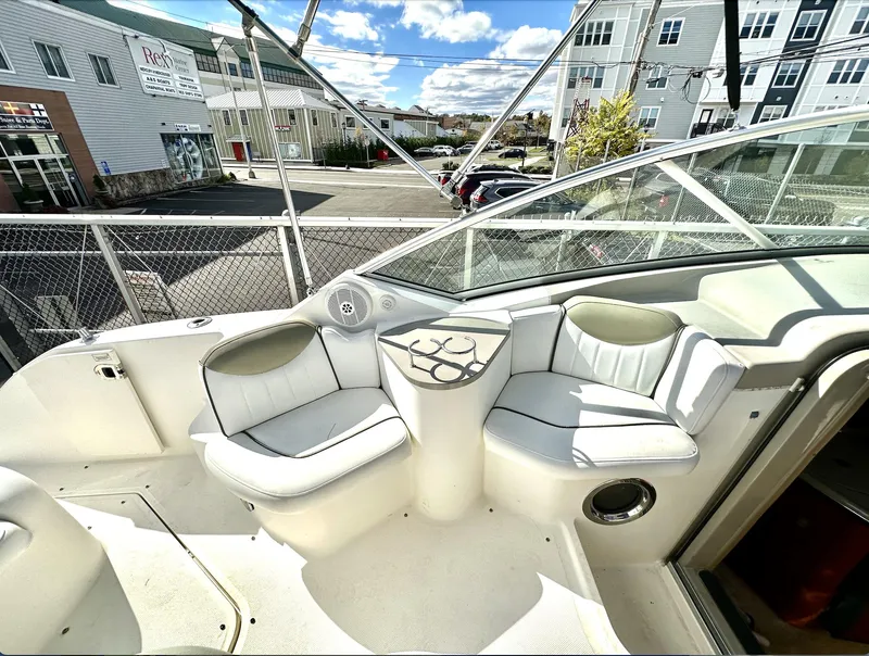 Slide: The Image of 2007 Sea Ray 240 Sundancer boat interior with white seating and table. - 28