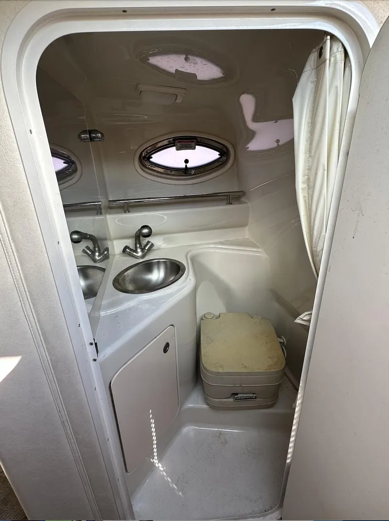 Slide: The Image of 2007 Sea Ray 240 Sundancer bathroom with sink and porthole window. - 31