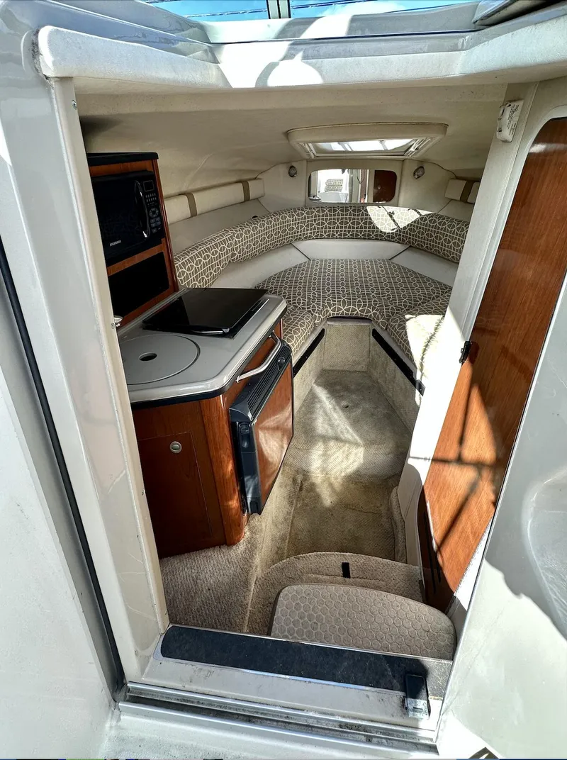 Slide: The Image of 2007 Sea Ray 240 Sundancer cabin interior with kitchenette and seating area. - 32