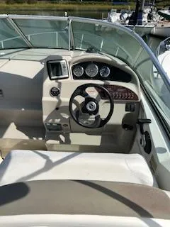 Slide: The Image of 2007 Sea Ray 240 Sundancer boat cockpit with steering wheel and dashboard controls. - 38