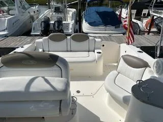 Slide: The Image of 2007 Sea Ray 240 Sundancer boat interior with white seating at a marina. - 40