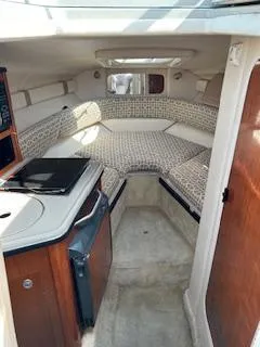 Slide: The Image of Interior of 2007 Sea Ray 240 Sundancer boat, featuring cozy cabin and kitchenette. - 41