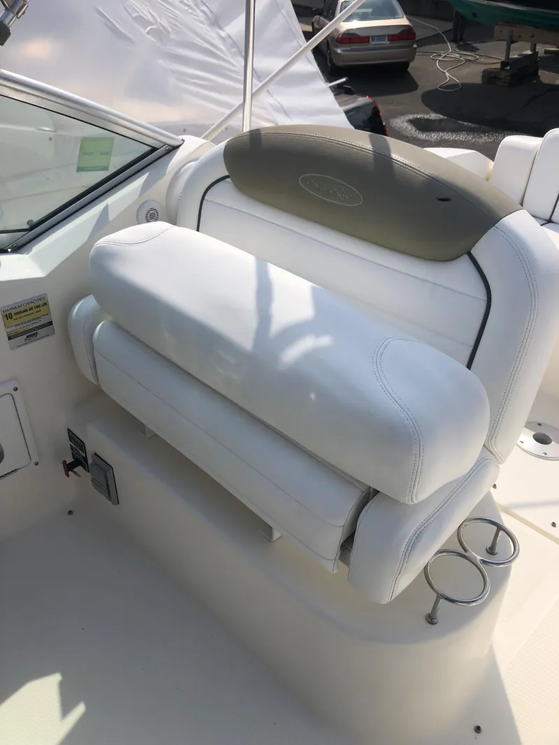 Slide: The Image of 2007 Sea Ray 240 Sundancer boat seat with white upholstery and cup holders. - 5