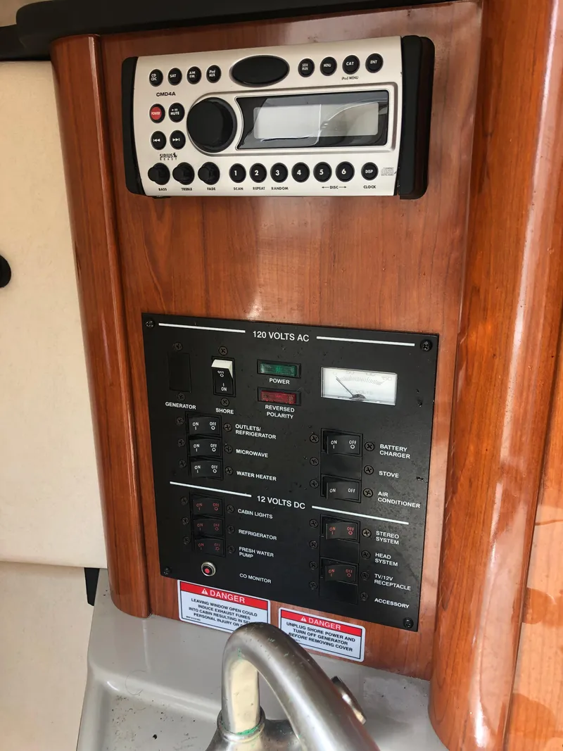 Slide: The Image of 2007 Sea Ray 240 Sundancer control panel with stereo system and electrical switches. - 6