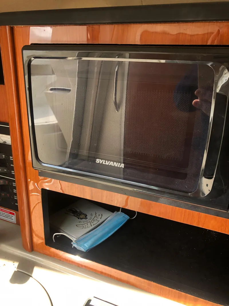 Slide: The Image of Microwave in 2007 Sea Ray 240 Sundancer cabin, with a face mask nearby. - 7