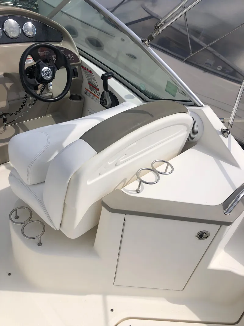 Slide: The Image of 2007 Sea Ray 240 Sundancer boat interior with helm and seating area. - 9