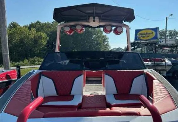 Slide: The Image of 2024 Tigé 24RZX boat with red and white seating, outdoor setting. - 4