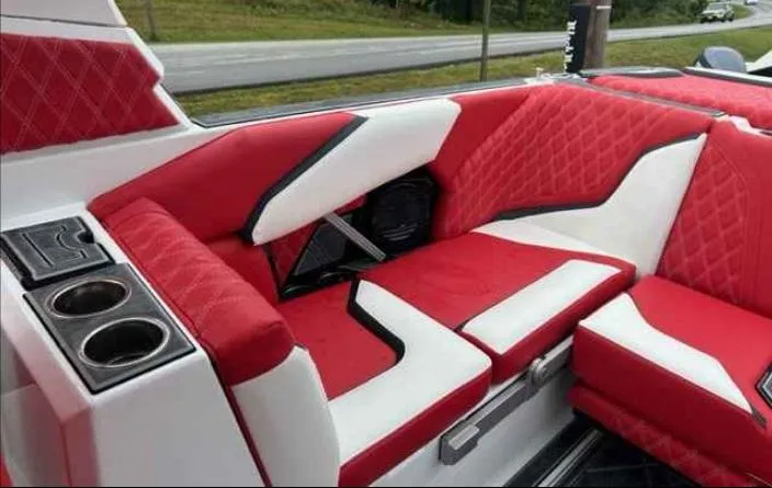 Slide: The Image of 2024 Tigé 24RZX boat interior with red and white upholstery and cup holders. - 5