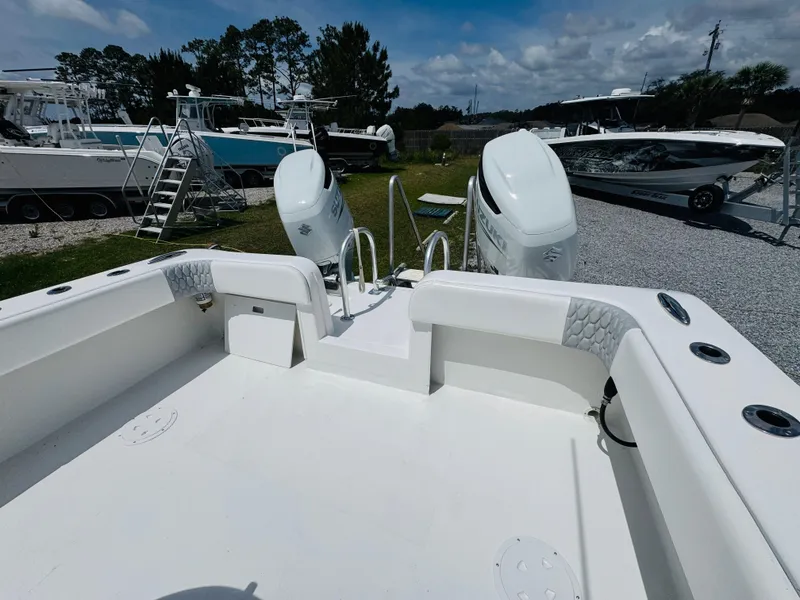 Slide: The Image of 2022 Twin Vee 310 CC GF Classic boat with dual engines, parked outdoors. - 10