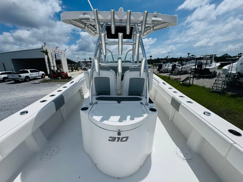 Slide: The Image of 2022 Twin Vee 310 CC GF Classic boat, center console, white interior, outdoor setting. - 11