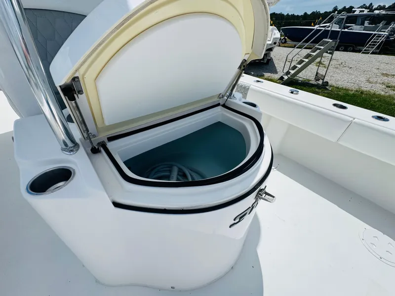 Slide: The Image of 2022 Twin Vee 310 CC GF Classic boat with open storage compartment on deck. - 12