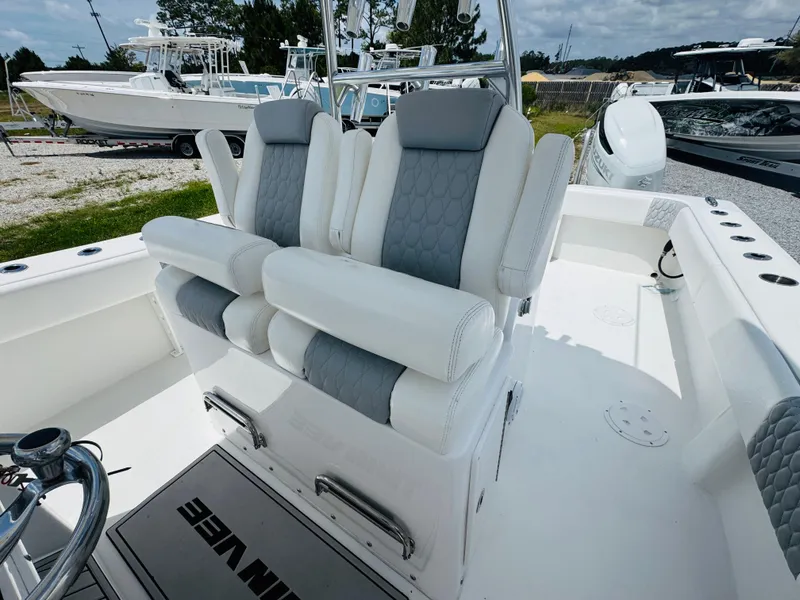 Slide: The Image of 2022 Twin Vee 310 CC GF Classic boat with dual cushioned seats and sleek design. - 13