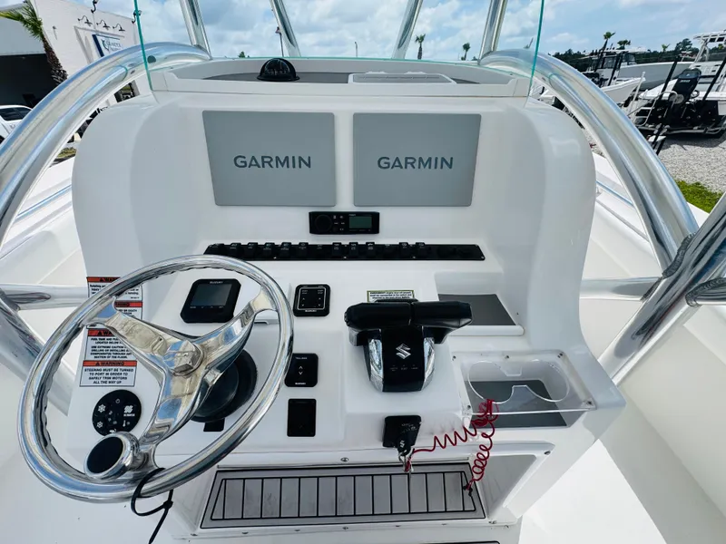 Slide: The Image of 2022 Twin Vee 310 CC GF Classic boat console with dual Garmin displays and steering wheel. - 14