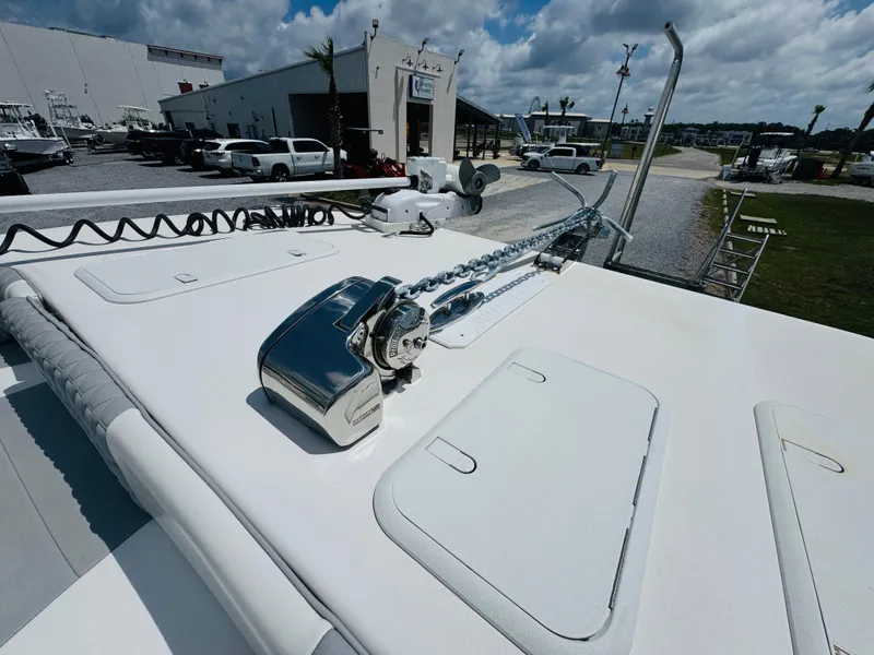 Slide: The Image of 2022 Twin Vee 310 CC GF Classic boat deck with anchor chain and storage hatches. - 18