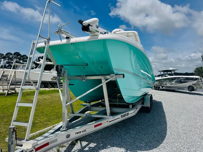 Slide: The Image of 2022 Twin Vee 310 CC GF Classic boat on trailer, turquoise hull, outdoor display. - 5