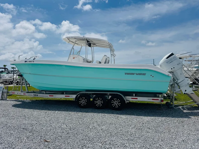 Slide: The Image of 2022 Twin Vee 310 CC GF Classic boat on trailer under blue sky. - 7