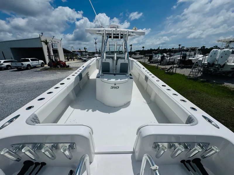 Slide: The Image of 2022 Twin Vee 310 CC GF Classic boat with spacious deck and center console. - 9