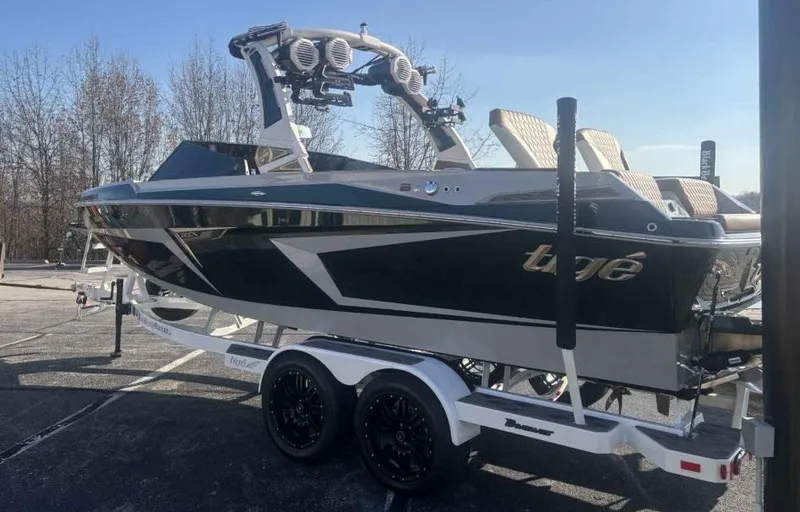 Slide: The Image of 2024 Tigé 22RZX boat on trailer, sleek design, black and white color scheme. - 2