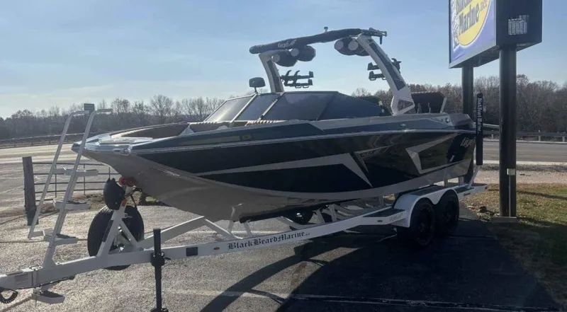 Slide: The Image of 2024 Tigé 22RZX boat on trailer, parked outdoors, side view. - 3