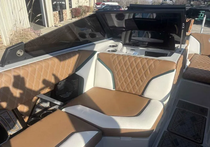 Slide: The Image of 2024 Tigé 22RZX boat interior with brown and white seating, diamond stitching, and modern design. - 5