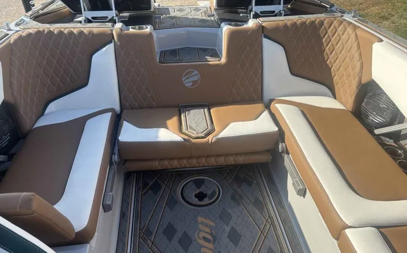 Slide: The Image of 2024 Tigé 22RZX boat interior with brown and white quilted seating. - 6