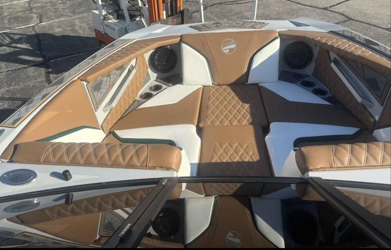 Slide: The Image of 2024 Tigé 22RZX boat interior with tan and white seating, diamond stitching, and cup holders. - 7