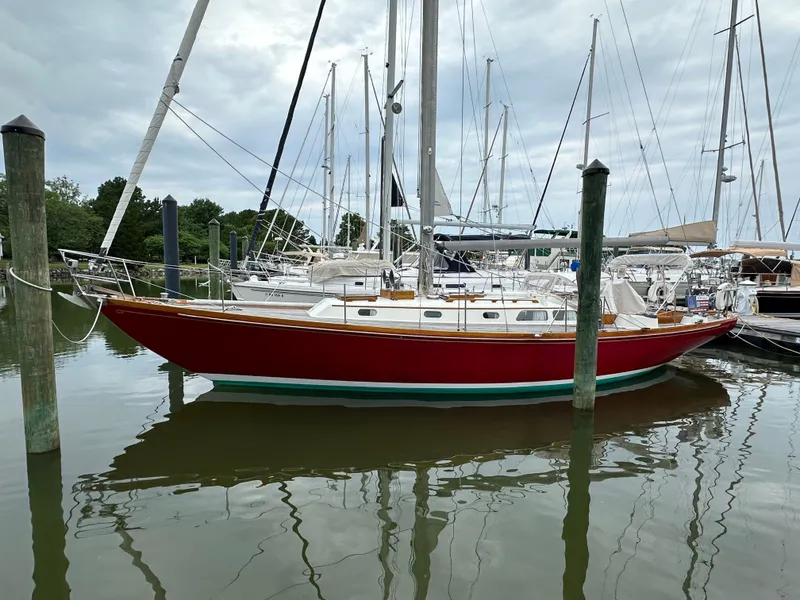 The Image of 1978 Hinckley Bermuda 40 MK III sailboat docked in a marina, overcast sky. - 0
