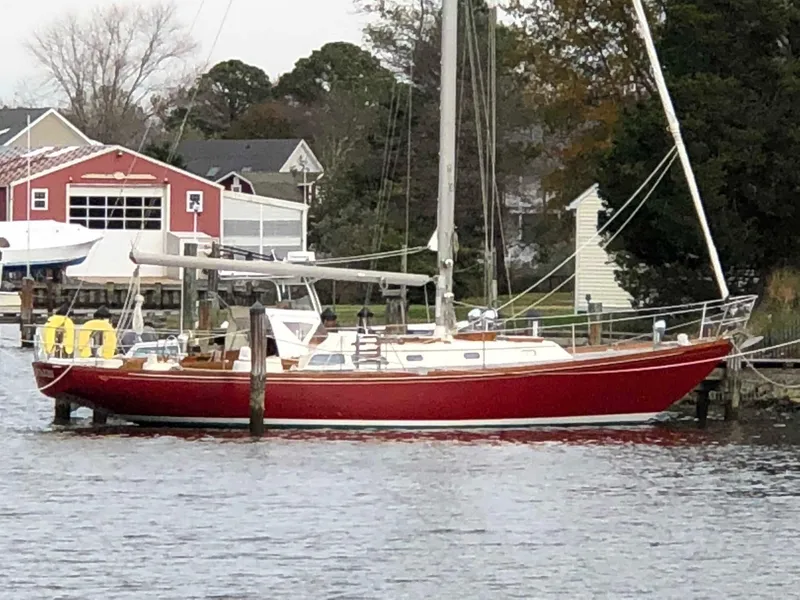 Slide: The Image of 1978 Hinckley Bermuda 40 MK III sailboat docked by waterfront homes. - 10