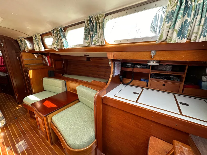 Slide: The Image of Interior of 1978 Hinckley Bermuda 40 MK III sailboat with wood finish and seating area. - 13