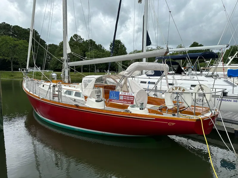 Slide: The Image of 1978 Hinckley Bermuda 40 MK III sailboat with red hull, docked and for sale. - 2
