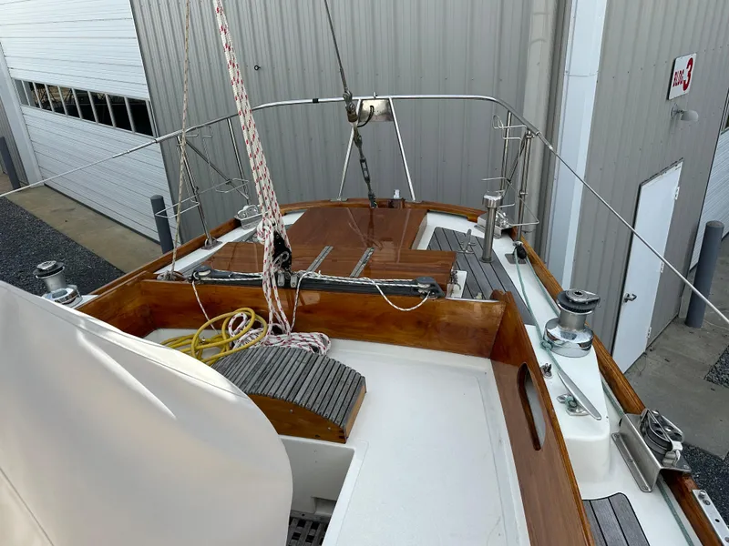 Slide: The Image of 1978 Hinckley Bermuda 40 MK III sailboat deck with wooden accents and rigging. - 21