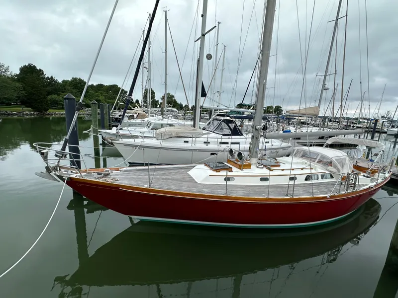 Slide: The Image of 1978 Hinckley Bermuda 40 MK III sailboat docked in a marina, overcast sky. - 28