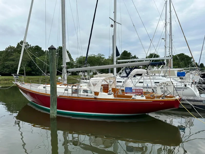 Slide: The Image of 1978 Hinckley Bermuda 40 MK III sailboat docked, red hull, for sale sign visible. - 29