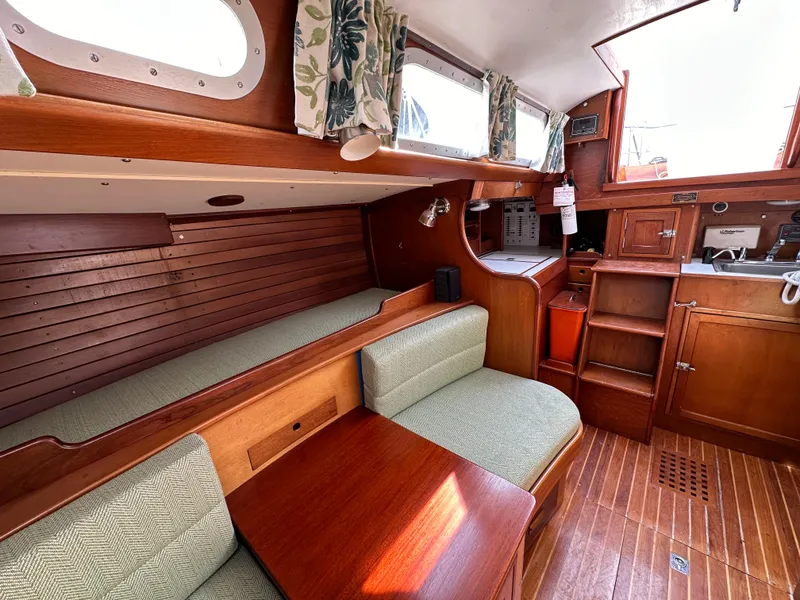 Slide: The Image of Interior of 1978 Hinckley Bermuda 40 MK III sailboat with wood finish and seating area. - 4