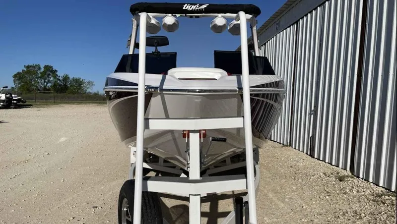 Slide: The Image of 2024 Tigé Z3 boat on trailer, parked outdoors near a metal building. - 3