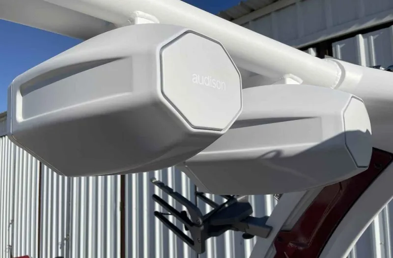 Slide: The Image of 2024 Tigé Z3 boat speakers, white, mounted on a metal frame, outdoor setting. - 8