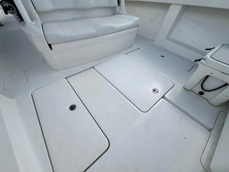 Slide: The Image of 2016 Invincible 39' Open Fisherman boat interior with white seating and deck storage. - 10