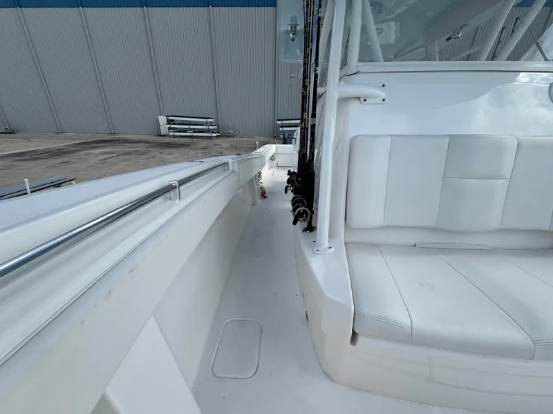 Slide: The Image of 2016 Invincible 39' Open Fisherman boat interior with white seating and fishing rod holders. - 12