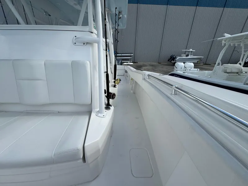 Slide: The Image of 2016 Invincible 39' Open Fisherman boat, white interior, docked near other vessels. - 13