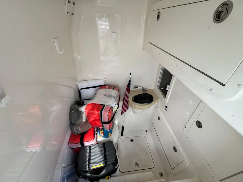 Slide: The Image of 2016 Invincible 39' Open Fisherman cabin interior with storage and American flag. - 15