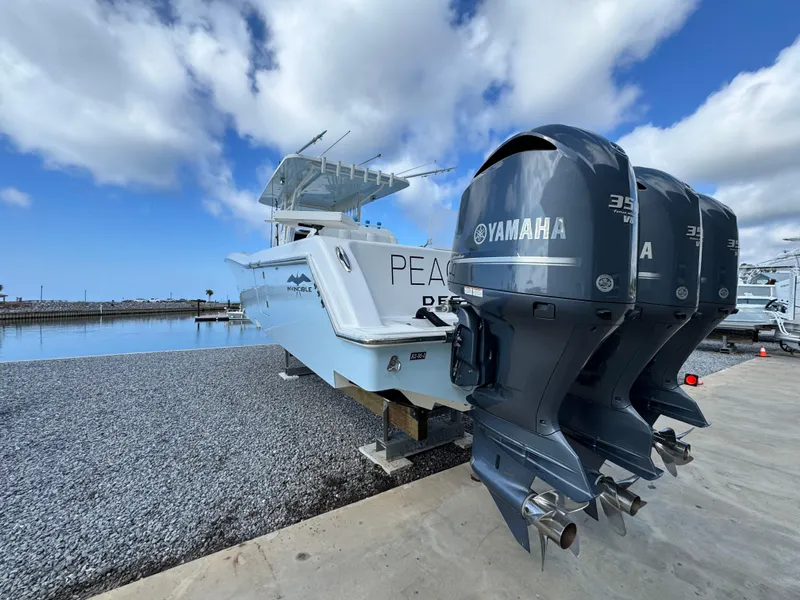 Slide: The Image of 2016 Invincible 39' Open Fisherman with Yamaha engines docked by the water. - 3