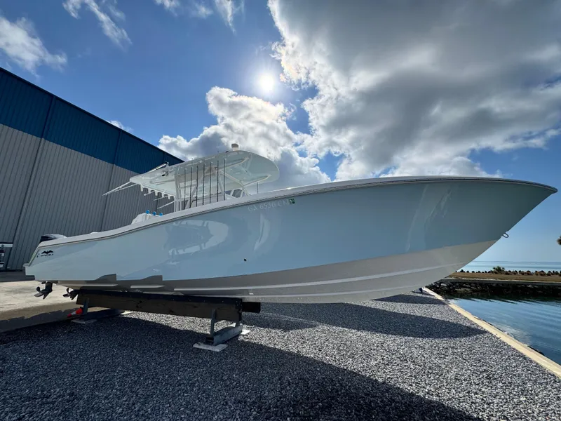 Slide: The Image of 2016 Invincible 39' Open Fisherman boat on display under a bright sky. - 5