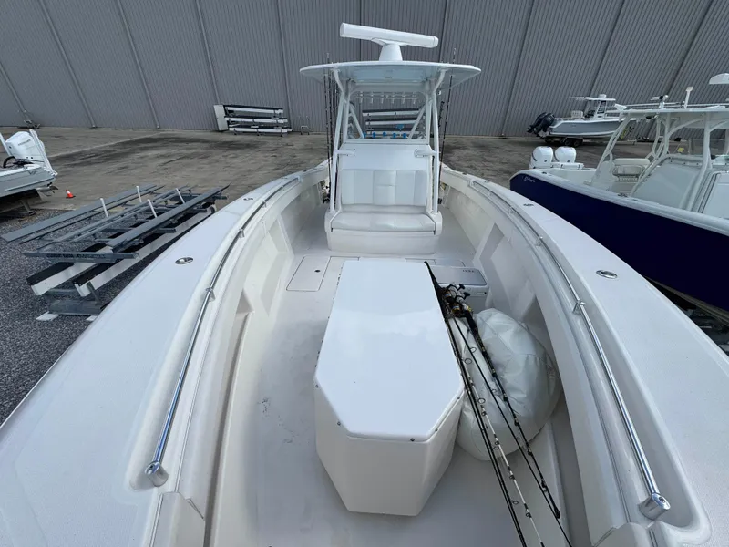 Slide: The Image of 2016 Invincible 39' Open Fisherman boat, spacious deck, fishing rods, and modern design. - 9