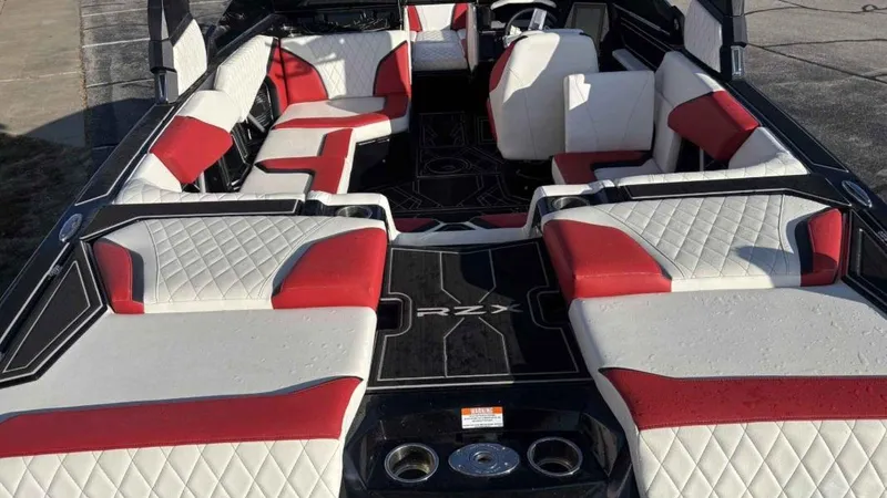 Slide: The Image of 2023 Tigé 22RZX boat interior with red and white seating, black flooring. - 5